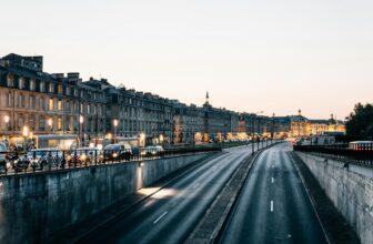 Traffic and lights in street at dusk. Bordeaux
